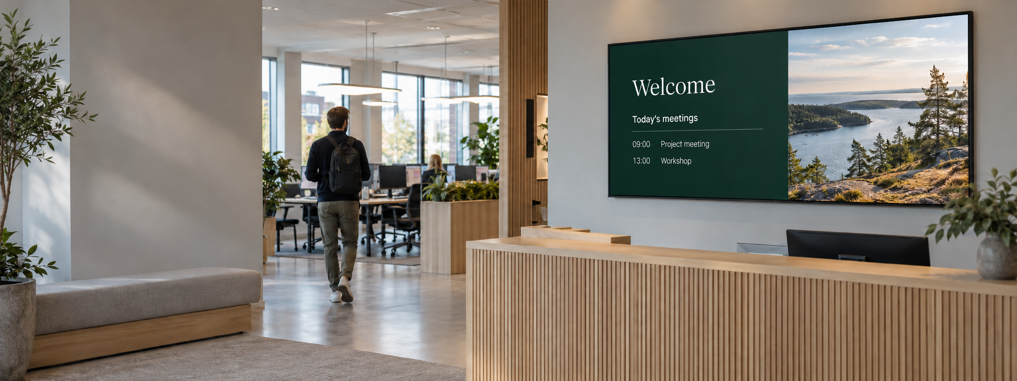 Digital welcome screen in a bright office reception.